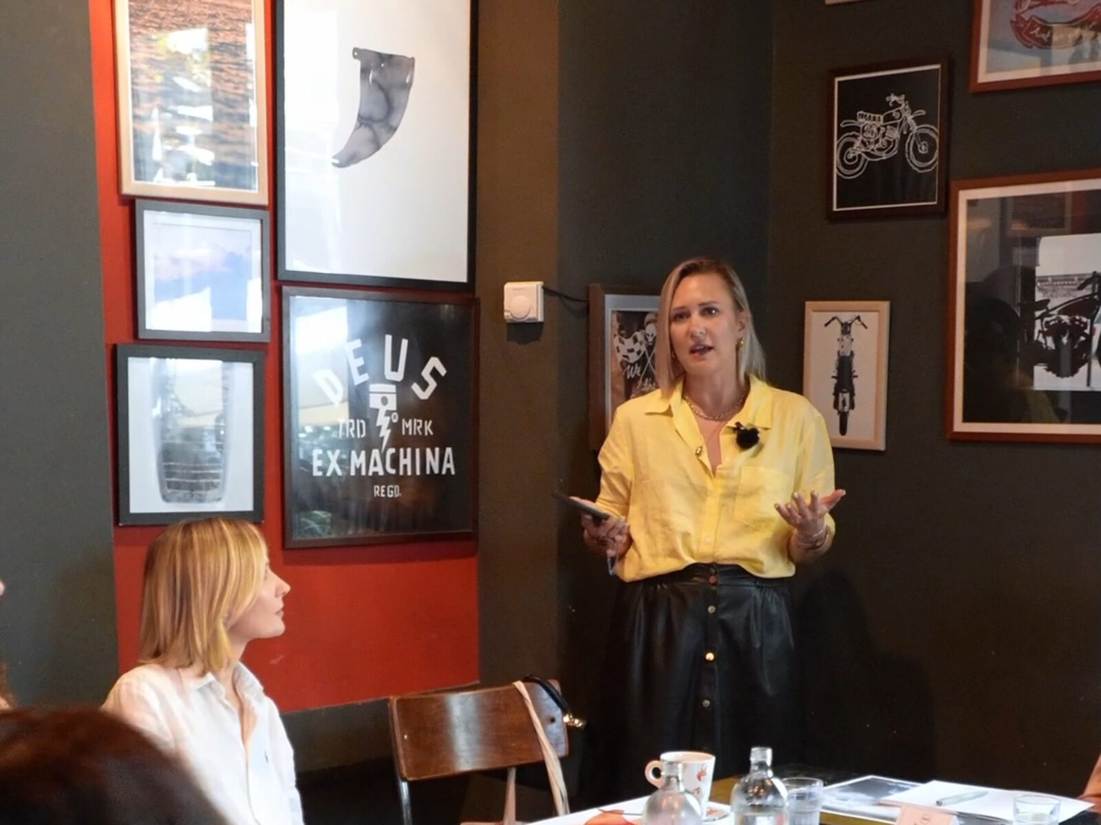 Indre speaking to a group of women at a private event